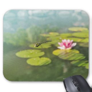 A dragonfly hovering above a lily pond mousepads