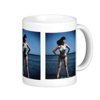 Bettie Page in a Blue Bikini Standing Beside Water Mugs