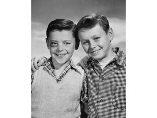 Portrait of a boy with a black eye smiling with another boy standing beside him Poster Print (18 x 24)